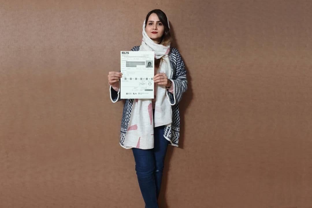 A girl holding her IELTS Sample report